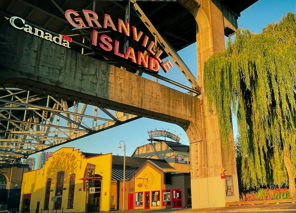 The Granville Island neon sign under the bridge at golden hour